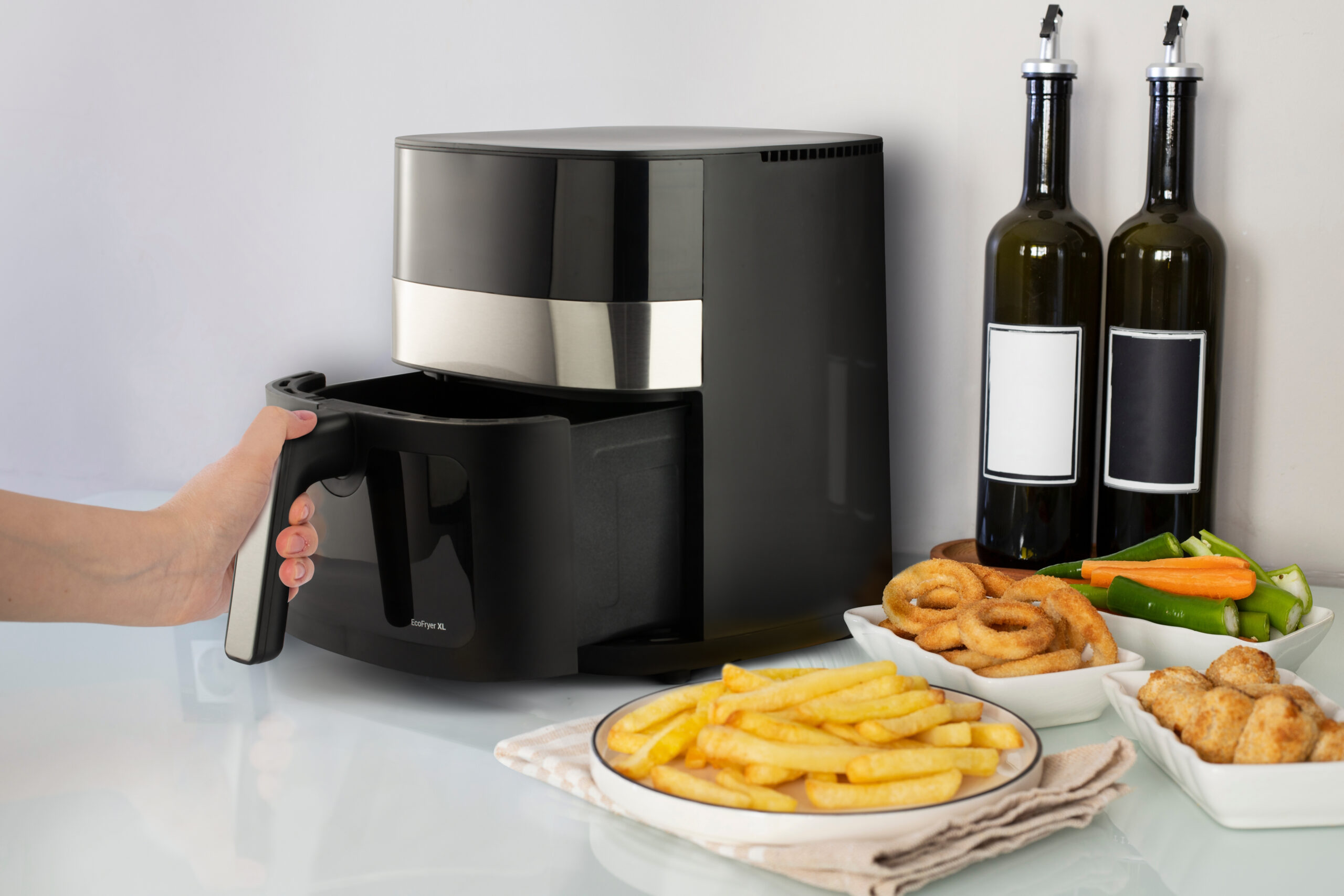 Woman cooking with modern Air fryer; Shutterstock ID 2248125439; purchase_order: -; job: -; client: -; other: -